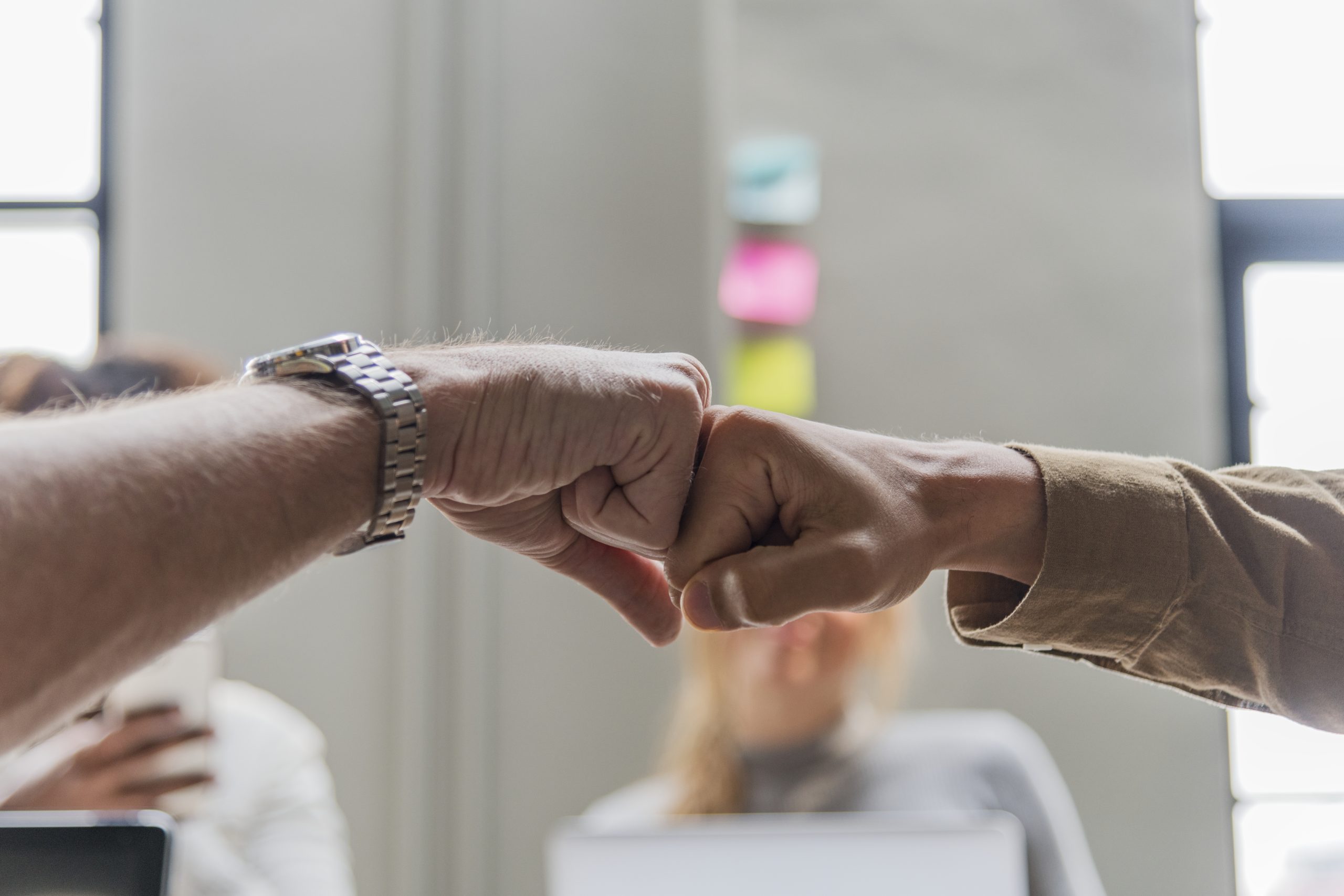 Two people giving a fist bump